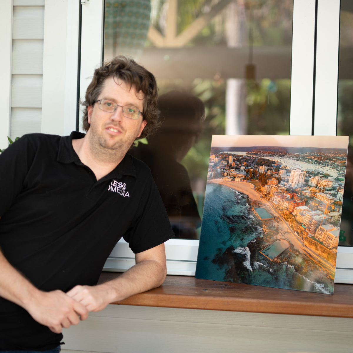 Alexander Kesselaar beside a Cronulla Pools I print