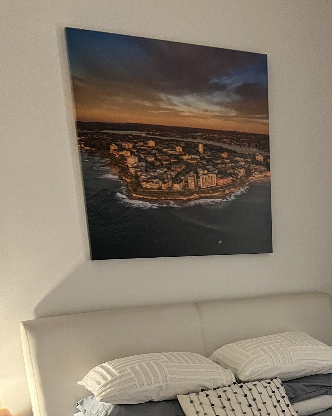 South Cronulla Sunrise print hanging above a bed in a collector's first home in South Cronulla
